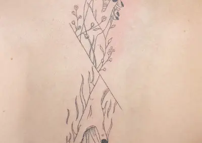 Tatouage fine line de serpents et branches fleuries sur le dos